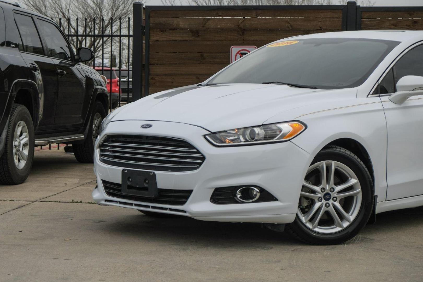 2016 white Ford Fusion Titanium AWD (3FA6P0D98GR) with an 2.0L L4 DOHC 16V engine, 6-Speed Automatic transmission, located at 2401 E Main St., Grand Prairie, TX, 75050, (972) 262-4440, 32.748981, -96.969643 - Photo#9